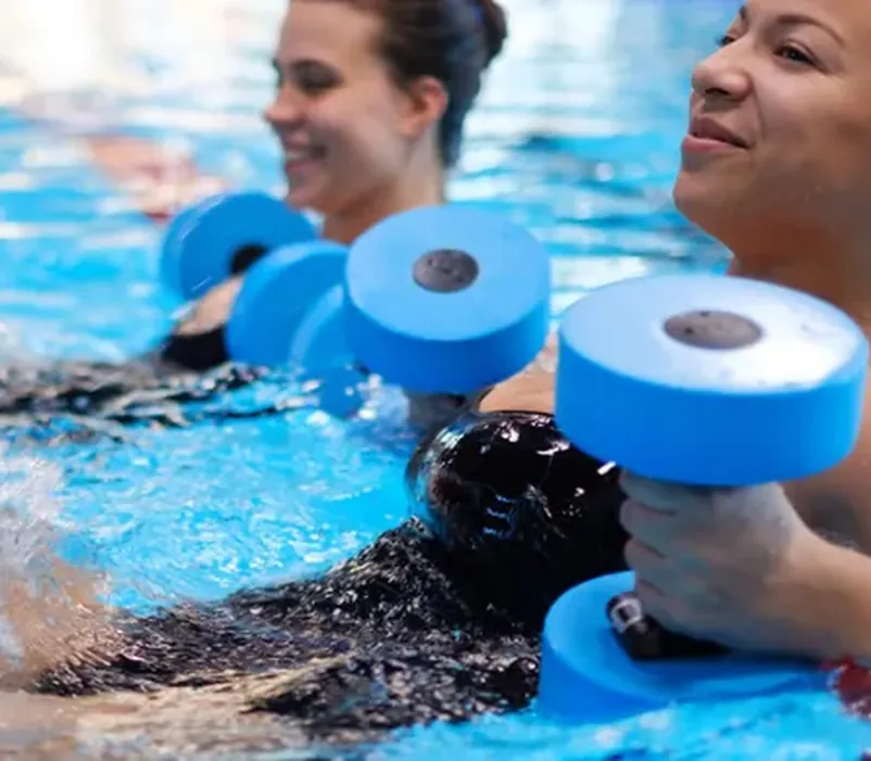 Patients performing aquatic therapy exercises in a warm-water therapy pool